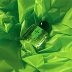 Janus Eau de Parfum, the first installment of Chronotope Perfume’s newest collection of fragrances called the Neon Series, rests atop a crinkled background of neon green vinyl.